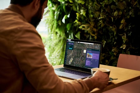 Nimbus_Man on Laptop with coffee_Mockup